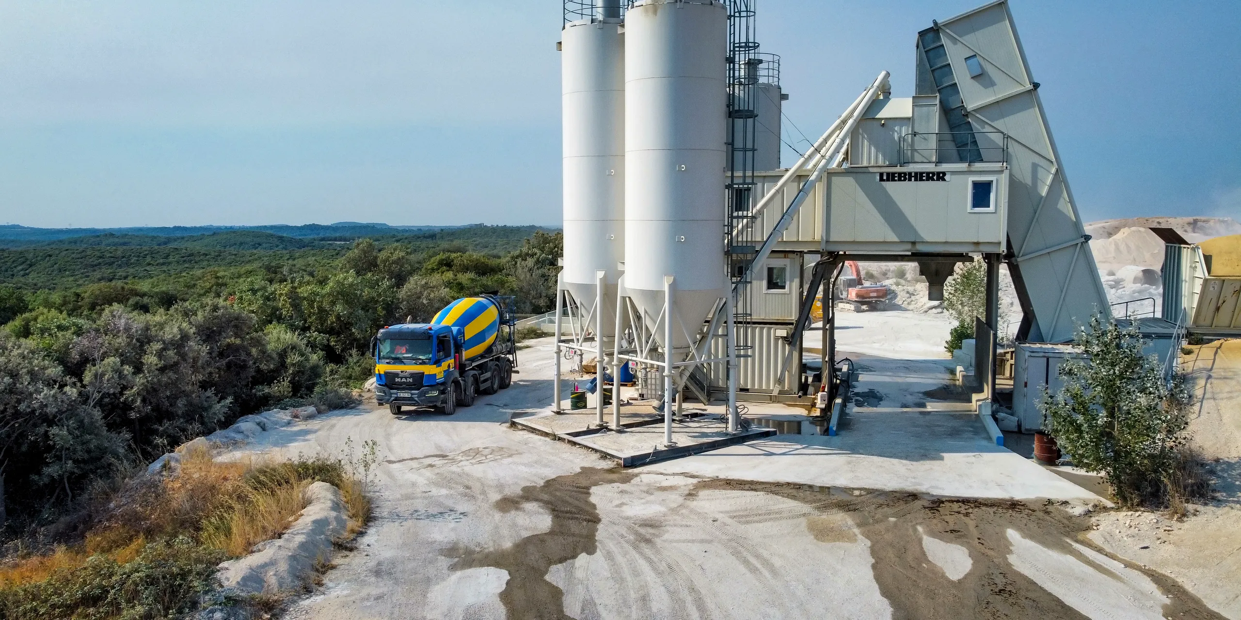 Centrale à béton BCGA de Saint-Laurent-la-Vernède, ses silos et un camion-toupie au-dessus de la garrigue